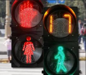 Detalle de figura femenina y masculina en un semáforo
